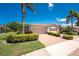 Charming home exterior featuring a brick driveway, well-manicured landscaping, and a spacious two-car garage at 13392 Abercrombie Dr, Englewood, FL 34223