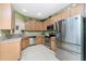 Modern kitchen with stainless steel appliances, granite counters, and ample cabinet space at 13392 Abercrombie Dr, Englewood, FL 34223