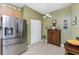 Kitchen with stainless steel fridge, cabinet, and tile flooring at 13392 Abercrombie Dr, Englewood, FL 34223