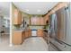 Updated kitchen showcasing tile floors, stainless steel appliances, and light wood cabinets at 13392 Abercrombie Dr, Englewood, FL 34223