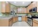 Well-equipped kitchen featuring stainless steel appliances, tile floors, and ample counter space at 13392 Abercrombie Dr, Englewood, FL 34223