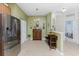An open kitchen with tile floors and stainless steel refrigerator at 13392 Abercrombie Dr, Englewood, FL 34223