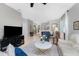 Open living space featuring tile flooring, an abundance of light, and stylish furnishings at 13392 Abercrombie Dr, Englewood, FL 34223