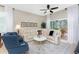 Bright and airy living room featuring neutral tones, tile floors and access to the patio at 13392 Abercrombie Dr, Englewood, FL 34223