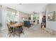 Bright living area showcasing tile floors, a ceiling fan, and a view of the outdoor patio at 13392 Abercrombie Dr, Englewood, FL 34223