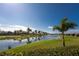 Scenic view of a pond adorned with fountains, surrounded by lush landscaping and serene atmosphere at 13392 Abercrombie Dr, Englewood, FL 34223