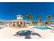 Community pool area featuring a pool, a hot tub, lounge chairs and a nearby clubhouse at 13392 Abercrombie Dr, Englewood, FL 34223