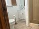 Bathroom featuring a toilet, sink, and walk-in shower with white fixtures at 13561 Darnell Ave, Port Charlotte, FL 33981