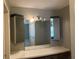 Bathroom vanity area with ample counter space, lighted mirror, and storage cabinets at 13561 Darnell Ave, Port Charlotte, FL 33981