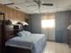 Bedroom featuring wood paneling, tiled floor, and a comfortable bed with blue patterned linens at 13561 Darnell Ave, Port Charlotte, FL 33981