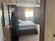 Bedroom featuring wood paneling, tiled floor, and a comfortable bed with blue patterned linens at 13561 Darnell Ave, Port Charlotte, FL 33981