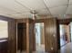 Bedroom with a ceiling fan, wood paneling, closet, and an en suite bathroom with walk-in shower at 13561 Darnell Ave, Port Charlotte, FL 33981