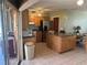 Functional kitchen features wooden cabinetry, stainless steel appliances, and island for additional counter space at 13561 Darnell Ave, Port Charlotte, FL 33981