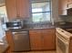 Efficient kitchen showcasing stainless steel appliances, ample cabinet space, and natural light at 13561 Darnell Ave, Port Charlotte, FL 33981