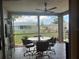 Screened lanai with tile flooring, ceiling fan, table and chairs with views of the backyard at 13561 Darnell Ave, Port Charlotte, FL 33981