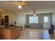 Living area showing the flow between kitchen and living room, featuring tile flooring and neutral color scheme at 13561 Darnell Ave, Port Charlotte, FL 33981