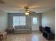 Cozy living room featuring neutral-toned walls, tile flooring, and a comfortable couch at 13561 Darnell Ave, Port Charlotte, FL 33981