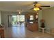 Bright, open living area with tile floors, ceiling fans, and sliding glass doors to the screened lanai at 13561 Darnell Ave, Port Charlotte, FL 33981