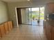 Open living area features tile flooring, access to lanai, and a view into the kitchen, enhancing flow at 13561 Darnell Ave, Port Charlotte, FL 33981