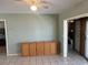 Well-lit living room boasts tile flooring, neutral paint, and adjacent rooms, providing ample living space at 13561 Darnell Ave, Port Charlotte, FL 33981