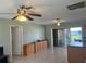 Spacious living room featuring tile floors, ceiling fans, and natural light, with access to lanai at 13561 Darnell Ave, Port Charlotte, FL 33981