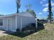 Side view of a home showing the utility access points, storage areas, and well-maintained yard at 13561 Darnell Ave, Port Charlotte, FL 33981