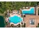 Stunning community swimming pool area with tropical landscaping, lounge chairs, and well-maintained tile walkways at 142 Savona Way, North Venice, FL 34275