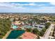 Active community featuring a pool, tennis courts, lush landscaping, and beautiful homes against a serene lake backdrop at 142 Savona Way, North Venice, FL 34275
