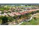 Aerial view of home showcasing beautiful landscaping, golf course, and lake views at 142 Savona Way, North Venice, FL 34275