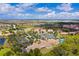 Scenic aerial view of the community highlighting the pool, tennis courts, lush landscape, and golf course at 142 Savona Way, North Venice, FL 34275