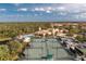 Vibrant community featuring tennis courts, a resort-style pool, and a clubhouse surrounded by lush landscaping at 142 Savona Way, North Venice, FL 34275