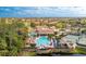 Resort-style community pool area with a large swimming pool, cabanas, tennis courts, and picturesque landscaping at 142 Savona Way, North Venice, FL 34275