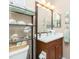 Bathroom with a dark wood vanity, decor, and a large mirror at 142 Savona Way, North Venice, FL 34275