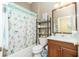 Bathroom featuring a shower and tub combination with a seashell-themed shower curtain at 142 Savona Way, North Venice, FL 34275