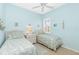 Charming blue bedroom with two twin beds and coastal decor at 142 Savona Way, North Venice, FL 34275
