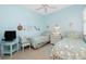 Bright blue bedroom featuring twin beds and nautical-themed decorations at 142 Savona Way, North Venice, FL 34275