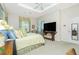 Cozy bedroom with large window, neutral carpet, and green accents at 142 Savona Way, North Venice, FL 34275