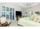 Bright bedroom featuring shutters, a ceiling fan, and neutral decor at 142 Savona Way, North Venice, FL 34275