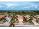 Inviting single-Gathering home with a tile roof, attached garage, and a beautifully landscaped front yard with mature palms at 142 Savona Way, North Venice, FL 34275