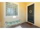 Inviting front entry with glass block window, bench, and decorative door at 142 Savona Way, North Venice, FL 34275