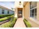 Covered front porch with decorative brick flooring and space for seating at 142 Savona Way, North Venice, FL 34275