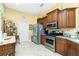 Modern kitchen with stainless steel appliances, granite countertops, and ample cabinet space at 142 Savona Way, North Venice, FL 34275