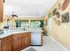 Bright kitchen area with granite countertops, stainless steel dishwasher and appliances, and stylish decor at 142 Savona Way, North Venice, FL 34275