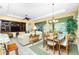 Spacious living room and dining area with plenty of natural light and comfortable seating arrangement at 142 Savona Way, North Venice, FL 34275