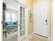 Entryway leading to the living room with a comfortable couch at 142 Savona Way, North Venice, FL 34275