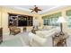 Comfortable living room featuring built-in shelving, cozy seating, and access to the outdoor space at 142 Savona Way, North Venice, FL 34275