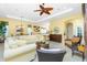 Cozy living room with comfortable seating, ceiling fan and elegant décor, perfect for relaxation and entertainment at 142 Savona Way, North Venice, FL 34275