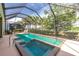 Beautiful screened-in pool and spa with views of lush landscaping and golf course, offering privacy and relaxation at 142 Savona Way, North Venice, FL 34275