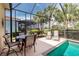 Inviting screened-in pool and spa with outdoor dining and lounge areas, perfect for entertaining and relaxation at 142 Savona Way, North Venice, FL 34275