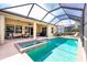 Inviting screened-in pool and spa area with a spacious patio and comfortable seating, creating an outdoor oasis at 142 Savona Way, North Venice, FL 34275